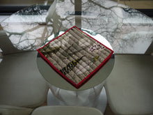 Load image into Gallery viewer, Feather Print Trivet with Red Trim
